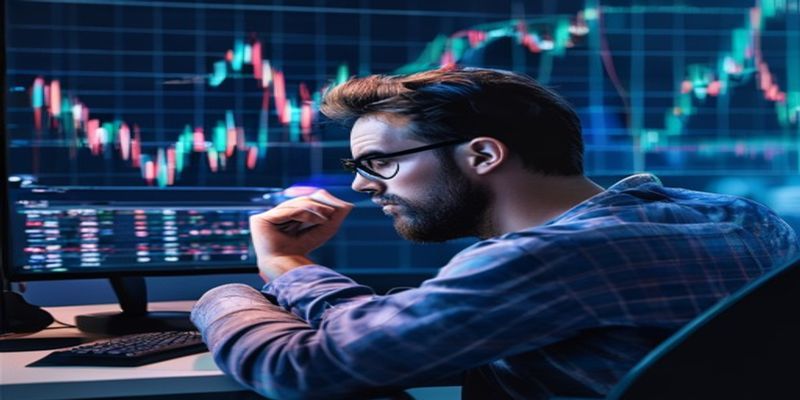 trader looking exhausted at computer screen with declining chart in background
